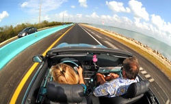 Amy Pierson, left, and Ken Mausolf drive on the new "18-mile Stretch" near Key Largo, Fla.,  that connects the Florida Keys to the South Florida mainland. The barrier's Belize blue color was chosen by marine artist Wyland to match Florida Keys' waters and skies. Photo by Andy Newman/Florida Keys News Bureau 